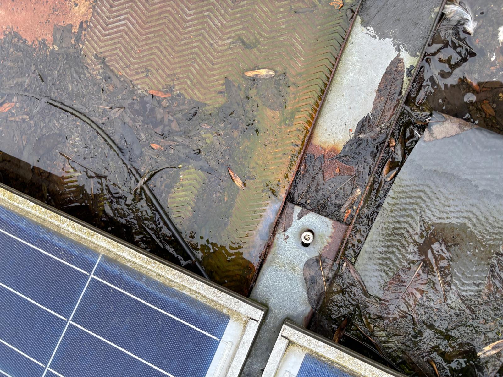 DC cables in standing water beneath solar panels